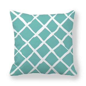 Close-up of minimalist teal cushion cover featuring a white hand-drawn grid pattern