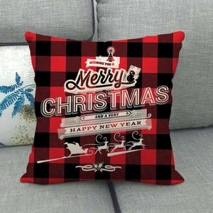 Detail of red and black buffalo plaid Christmas pillow cover with reindeer graphics