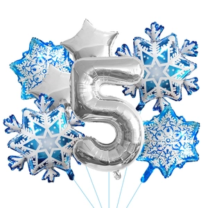 Detail of blue snowflake foil balloons and silver number five for party decoration
