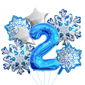 Close-up of number 2 foil balloon with blue snowflake and silver star party decorations