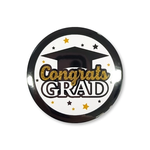 Macro detail of glossy Graduation badge featuring Congrats GRAD text and a black mortarboard