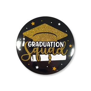 Detailed view of Graduation Squad badge with gold glitter mortarboard and scroll design