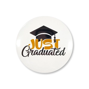 Detailed view of Graduation tinplate badge with JUST Graduated text and doctoral cap icon