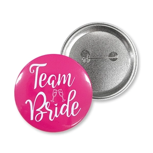 Front and back detail of pink Team Bride tinplate badge with safety pin fastener