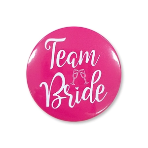 Close-up of pink Team Bride tinplate badge with gloss coating for bachelorette parties