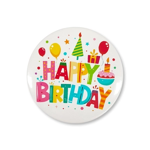 Macro shot of a white Happy Birthday tin badge with colorful balloons and cake designs