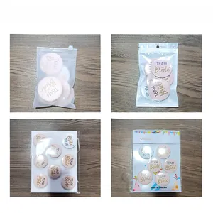 Detail view of Team Bride tinplate badges with various packaging options like frosted bags