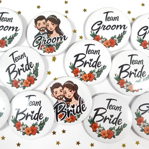 Detail of tinplate wedding badges with Team Bride and Groom floral designs