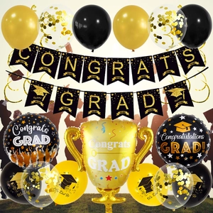 Detail of graduation party kit with trophy balloon, black and gold banners and latex balloons