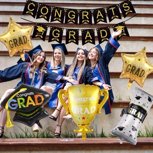 Party decor set with Congrats Grad banner and graduation themed foil balloons