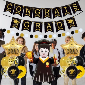Detail of black and gold graduation party set with Congrats Grad banner and balloons