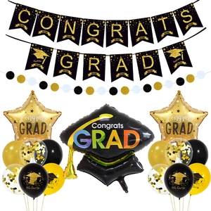 Detail of Congrats Grad banner with black and gold graduation party balloons and star foil