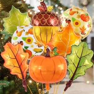 Detail view of foil autumn balloons featuring pumpkin, maple leaf and acorn for party decor