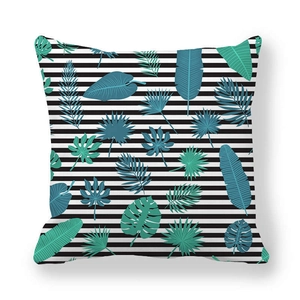 Close-up of peach skin pillowcase with black stripes and green tropical leaves