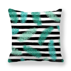 Detail of tropical palm leaves on black and white striped peach skin pillowcase