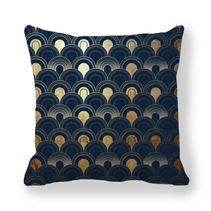Close-up of geometric fan pattern in gold on a navy blue peach skin pillowcase