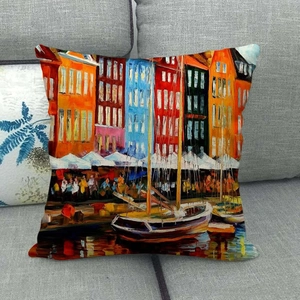 Close-up of linen cushion cover with colorful oil painting harbor print on a grey sofa