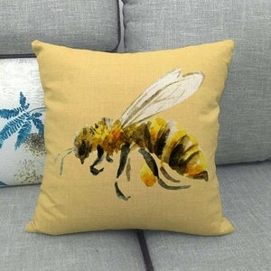 Detail of linen bee pillowcase showing the natural woven texture on a grey sofa