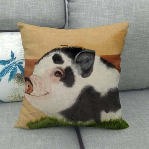 Detailed texture of linen cushion cover with hand-painted pig on gray sofa