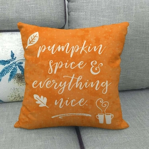 Orange autumn pillow case with Pumpkin Spice text on grey sofa home decor