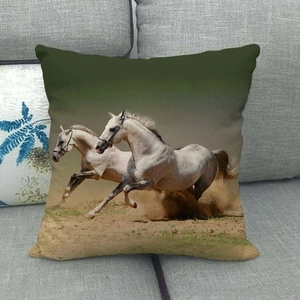 Running white horses digital print on linen pillowcase placed on a grey sofa
