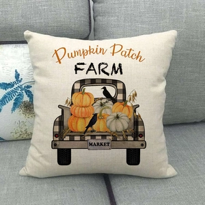 Modern Halloween linen pillow cover with vintage pumpkin truck and crow on gray sofa