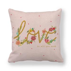 Detailed texture of pink linen pillowcase with gold Love is all you need text print