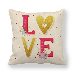 Detailed texture of linen cushion cover with pink LOVE text and gold heart pattern