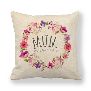 Close-up of linen pillowcase with floral wreath and Happy Mother's Day text print