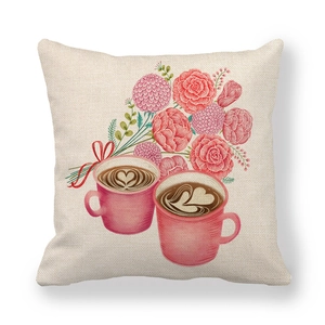 Detail of linen pillowcase featuring pink floral illustration and heart coffee cups