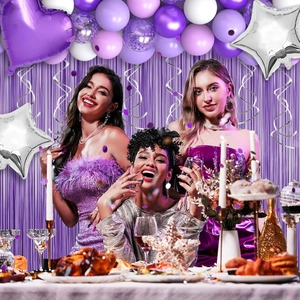 Detail of purple party balloon set with foil curtains and glitter star decorations