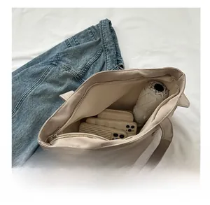 Top view of the spacious interior of a beige tote bag showing large storage capacity