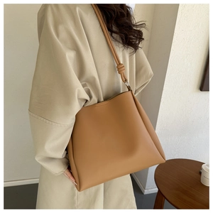 Detail of the soft leather knot shoulder bag handle and silver metal ring hardware