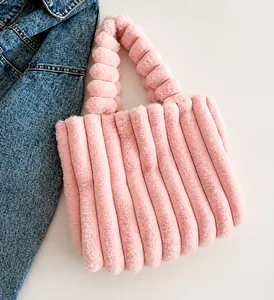 Pink plush tote bag with vertical quilted faux rabbit fur texture and soft handle detail