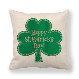 Detail of linen shamrock pillow cover with Happy St. Patrick's Day gold glitter text