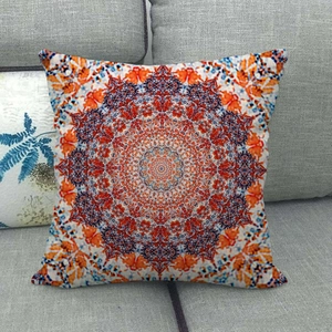 Linen style pillow cover with orange and blue mandala pattern on grey fabric sofa