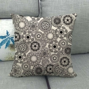 Gros plan du motif mandala géométrique sur une housse de coussin en lin beige