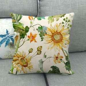 Decorative sunflower pattern linen throw pillow cover displayed on a grey fabric sofa