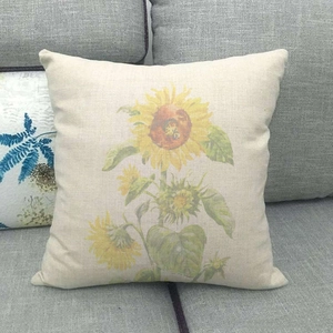 Close-up of linen pillowcase showing detailed sunflower print and natural fabric texture