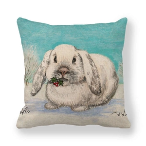 Macro detail of linen pillowcase featuring a cute white rabbit holding red winter berries