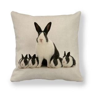 Detail of linen cushion cover showing realistic black and white rabbit family print