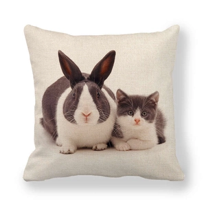 Close-up of linen pillowcase with digital print of a black rabbit and grey kitten