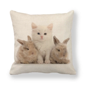 Macro detail of Easter linen pillowcase showing white kitten and brown bunnies on woven fabric