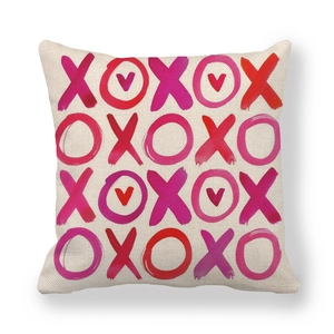 Detailed close-up of linen pillowcase with watercolor heart and XOXO festive patterns