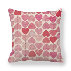 Detailed view of square linen pillowcase with vertical red heart pattern and woven texture
