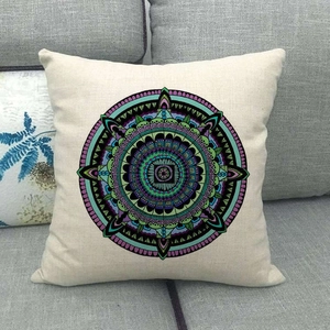 Detailed texture of geometric mandala pattern on linen pillowcase over a gray sofa