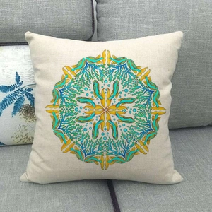 Close-up of linen cushion cover with blue mandala coral and seahorse ocean pattern