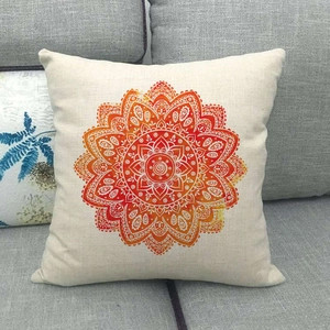 Macro view of geometric mandala linen pillow cover with vibrant orange gradient texture