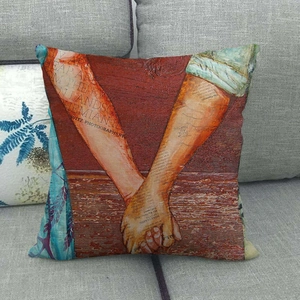 Detail of vintage bohemian art print linen pillowcase on a grey fabric sofa cushion