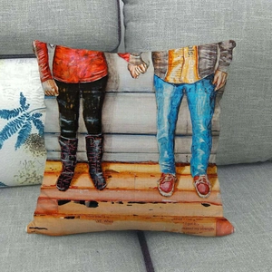 Detailed texture of linen cushion cover featuring painted couple holding hands on gray sofa